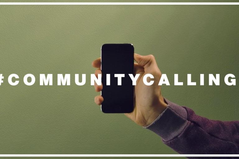 a hand holding a smart phone, with the text '#communitycalling' in the foreground