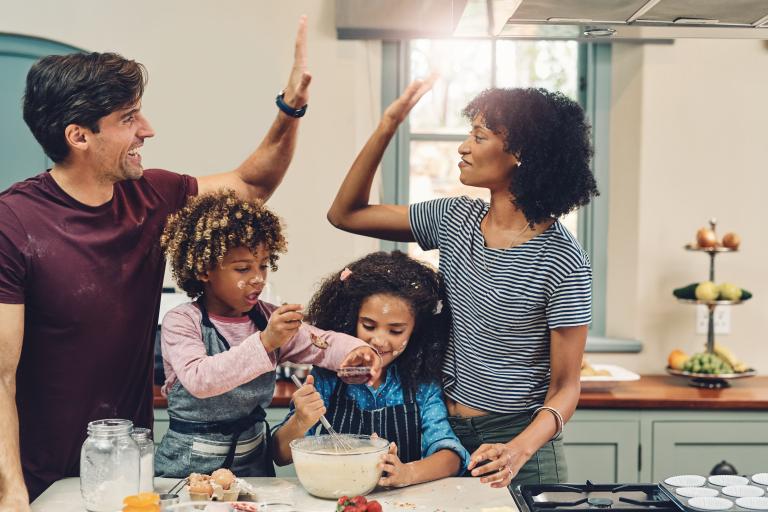Mixed race family having fun and cooking together