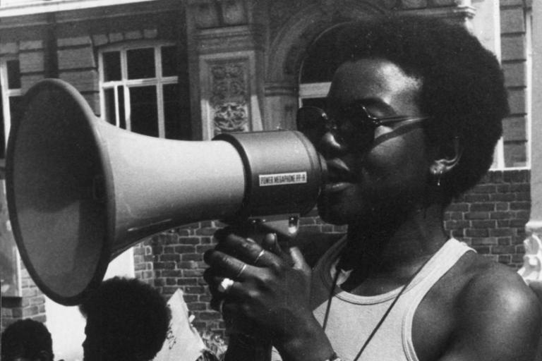 Black woman speaking through loudspeaker